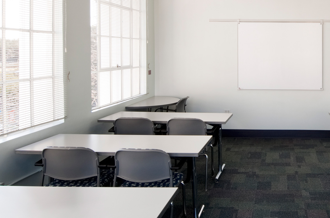 Class Room with 4 Long Tables and a White Board
